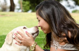 hispanic-woman-kissing-dog