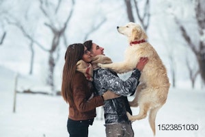 young-couple-holding-dog-outside