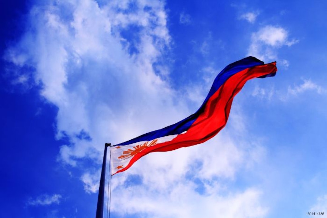 Philippine flag against a blue sky