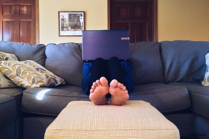 Person on couch with laptop