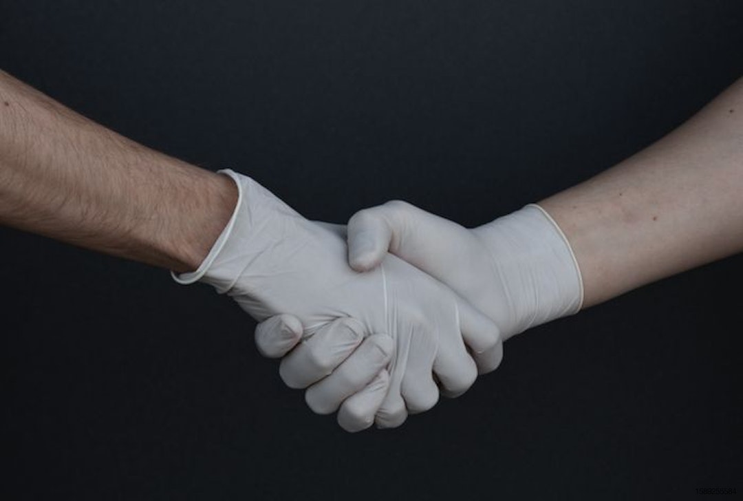 people shaking hands in latex gloves