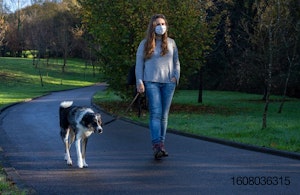 Woman-with-mask-on-walking-dog